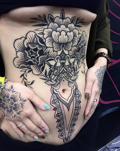 Experience the beauty of Giada Knox's ornamental dotwork tattoo featuring a stunning blackwork flower design.