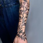 Elegant flower and branch design in bold blackwork style, expertly executed by artist Giada Knox.