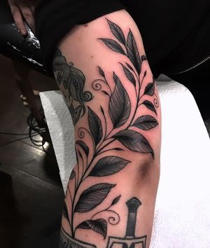 Embrace nature's beauty with this intricate vine and leaf blackwork tattoo by the talented artist Giada Knox.