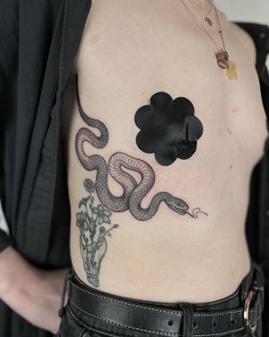 Get a striking snake tattoo in bold blackwork style by the talented artist Claudia Smith. A unique and timeless choice for your next ink.