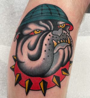 Get a classic traditional bulldog tattoo by renowned artist Liam Harbison. Bold lines and bright colors make this design stand out!