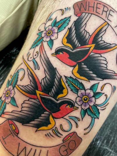 Get a timeless design with a swallow, flower, and banner by tattoo artist Liam Harbison. Perfect for those who appreciate classic and bold tattoos.