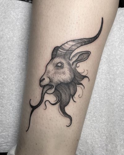 Embrace the beauty and strength of the goat with this striking blackwork tattoo by talented artist Claudia Smith.