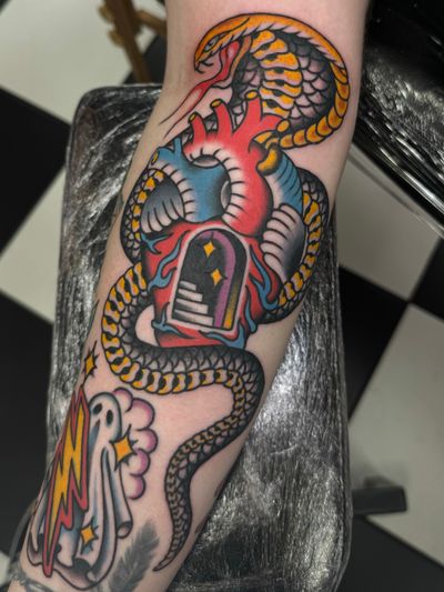 Get inked by Liam Harbison with a bold traditional design featuring a snake wrapped around a heart.
