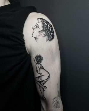 Capture the romance of French culture with this traditional tattoo featuring a man and woman. Created by the talented artist Ludo Matmut.