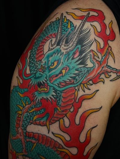 Immerse yourself in the mythical world of Japanese folklore with this powerful and intricately detailed dragon tattoo by the talented artist Liam Harbison.