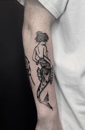 Get a stunning traditional mermaid tattoo done by the talented artist Ludo Matmut. Dive into the mystical world of mermaids with this unique design.