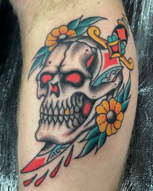 Get a classic traditional tattoo featuring a hauntingly beautiful skull, expertly done by renowned artist Liam Harbison.