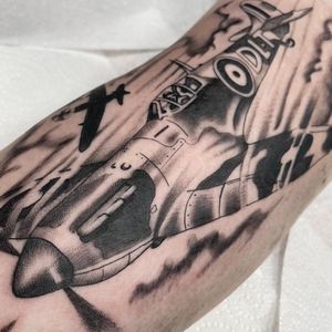 Capture the iconic aircraft of WWII in detailed black and gray by tattoo artist Liam Harbison. A timeless piece for aviation enthusiasts.