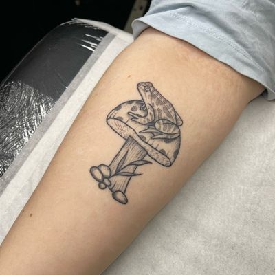 Unique and whimsical tattoo design featuring a frog and mushroom, created by Chris Harvey.