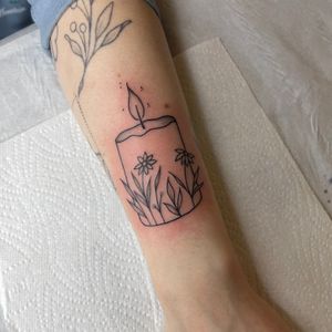 Transform your skin into a glowing masterpiece with this stunning illustrative candle tattoo by renowned artist Chris Harvey.