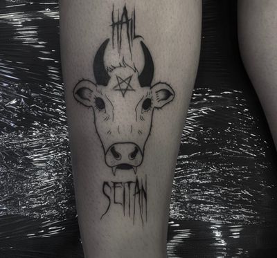 Express your wild side with this illustrative tattoo featuring a cow and devil motif by the talented artist Sophia Hayes.