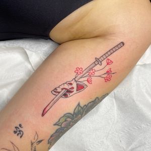 Beautiful illustrative tattoo featuring sakura blossoms, a sword, kitsune spirit, and katana by talented artist Chris Harvey.