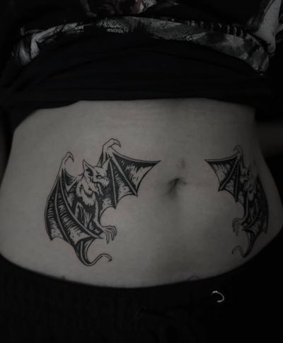 Get inked with this stunning blackwork and illustrative tattoo featuring a mysterious bat and a menacing gargoyle, brought to life by talented artist Sophia Hayes.