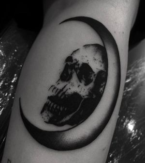 Unique blackwork tattoo featuring a moon and skull design by Sophia Hayes. Bold and striking!