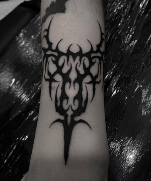 Unique tribal tattoo featuring a cyber sigil design, expertly executed in blackwork style by tattoo artist Sophia Hayes.
