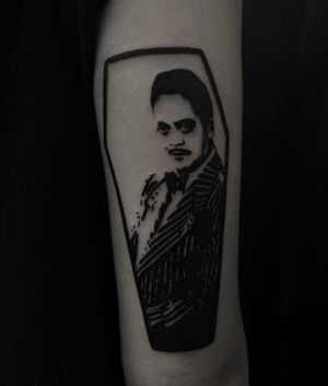 Get a stunning blackwork tattoo of Gomez Adams portrayed by the iconic Raul Julia, skillfully inked by Sophia Hayes.