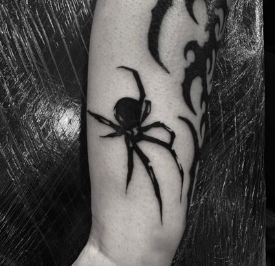 Explore the dark beauty of this stunning spider tattoo, expertly executed in blackwork style by the talented artist Sophia Hayes.