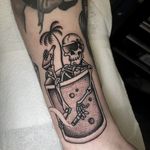 Unique dotwork and traditional style tattoo featuring a skull, drink, and skeleton by Barney Coles.