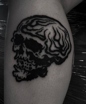 Experience the striking artistry of Sophia Hayes in this blackwork skull tattoo inspired by tribal motifs. Make a bold statement with this unique design.