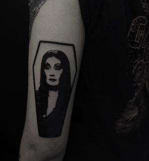 Stunning blackwork tattoo by Sophia Hayes featuring a portrait of Angelica Houston as Morticia Adams. Embrace the dark beauty.