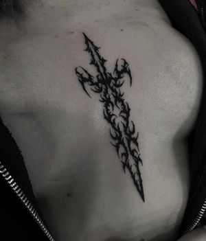 Embrace the powerful symbolism of a blackwork sword tattoo by talented artist Sophia Hayes. Bold and striking design that commands attention.
