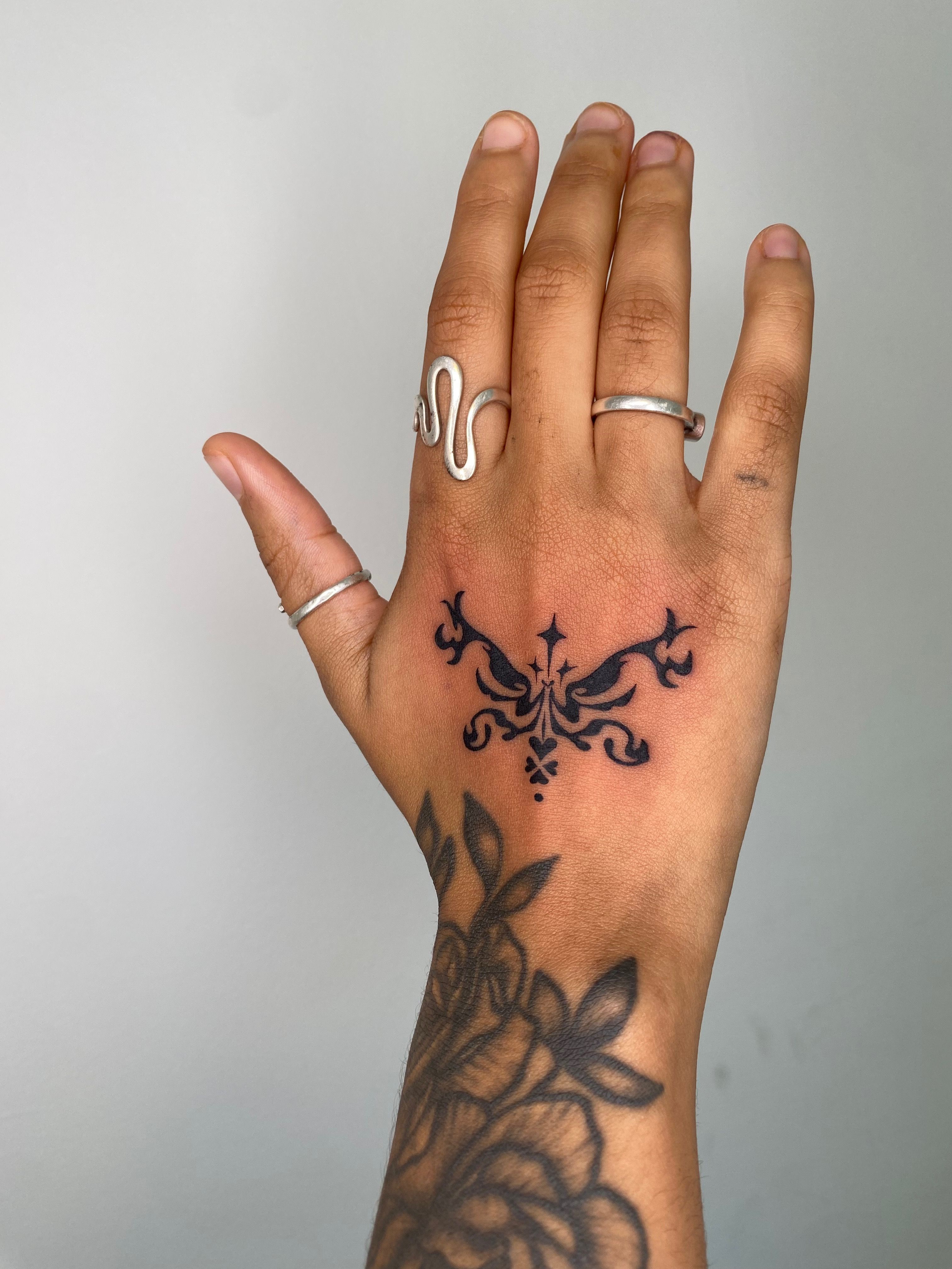 Minimal symmetrical blackwork star tattoo on Craiyon