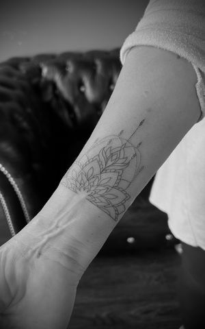 Beautiful fine line ornamental tattoo featuring a lotus flower and mandala design by Kateryna Goshchanska.