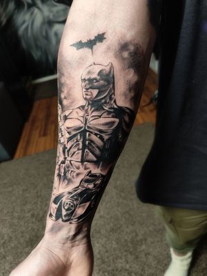 Batman and batmobile tattoo on forearm