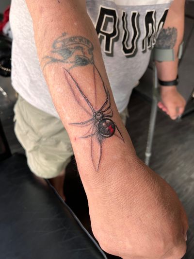 Realistic and detailed black widow spider tattoo in 3D style, created by artist Kateryna Goshchanska.