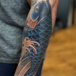 Stunning koi fish tattoo by Martin Kirke, featuring intricate Japanese design elements. A symbol of strength and perseverance.