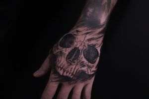 Get a striking blackwork skull tattoo designed by José, combining illustrative style and bold lines for a unique and edgy look.