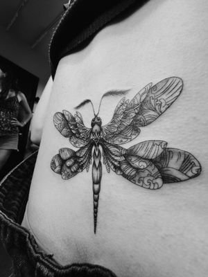 Embrace the beauty of nature with this stunning blackwork dragonfly tattoo by the talented artist Kateryna Goshchanska.