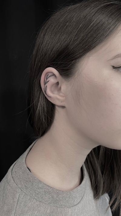 Leaf on ear , fine line tattoo