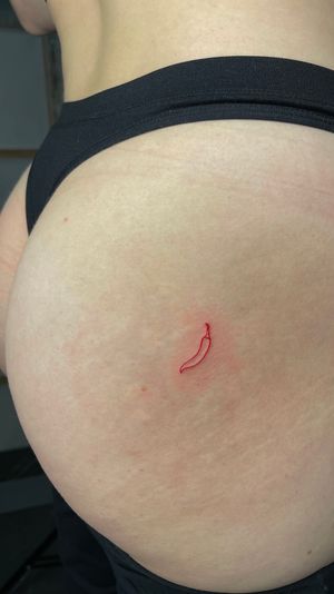 Red Chili pepper on ass, fine line tattoo