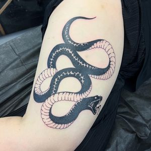 Bold blackwork snake design by skilled artist Hellie, sure to make a striking statement on your skin.