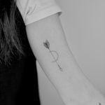 Fine line and geometric tattoo featuring a dainty arrow design by talented artist Ruth Hall.