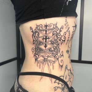 Embrace your dark side with this stunning blackwork corset tattoo by the talented artist Zanzi La Vey. Perfect for those who love goth and lace motifs.