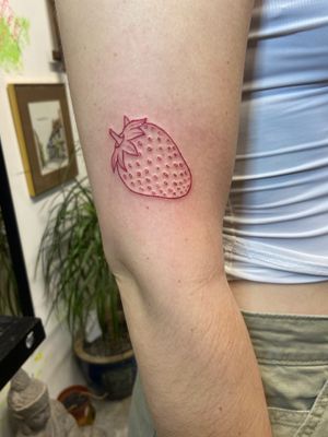 Get a taste of summer with this elegant fine line tattoo of a juicy red strawberry by Eve inksane.