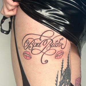 Elevate your style with a personalized touch by Zanzi La Vey's intricate lettering tattoo design. Make a bold statement with customized text.