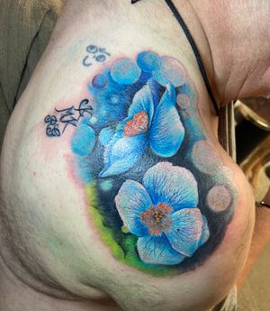 Experience the beauty of realism with this stunning violet flower tattoo by Eve inksane. Perfect for those who love color and nature.