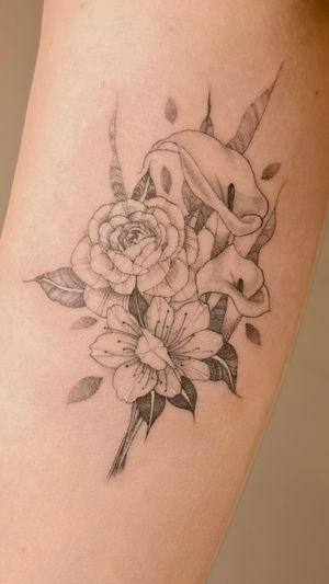 A small fine line bouquet with a rose, cherry blossoms and lilies 