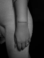 Get a stylish and delicate small lettering tattoo designed by the talented Kateryna Goshchanska.
