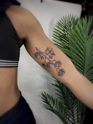 Get inked with a stunning black and gray Surinam cherry design by Kateryna Goshchanska. Showcase your love for nature with this elegant floral tattoo.
