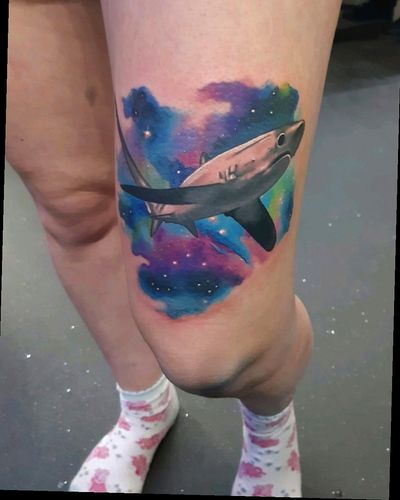 Experience the depths of space and ocean with this stunning watercolor tattoo by Craig Hicks.