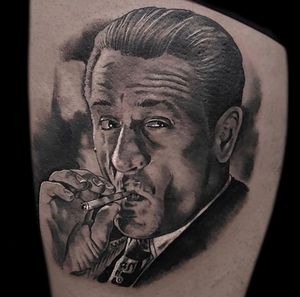 Captivating black and gray realism tattoo of Robert De Niro by Craig Hicks. Life-like detail and expert shading.