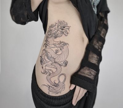 Detailed and intricate dragon design by fine line specialist Kateryna Goshchanska.