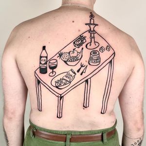 A unique tattoo by Woozy Machine featuring a table filled with delicious food items in an ignorant style.