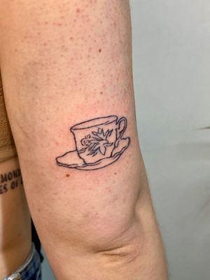 A stunning fine line hand poke tattoo of a charming tea cup design by Charlotte Pokes. Perfect for tea lovers who appreciate minimalistic art.
