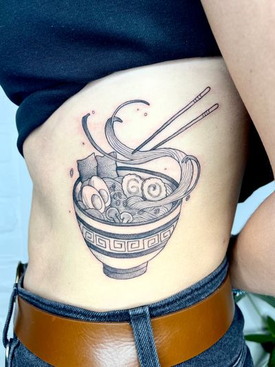 Satisfy your cravings with this illustrative ramen tattoo that showcases a mouthwatering bowl of noodles, designed by the talented artist Michelle Harrison.